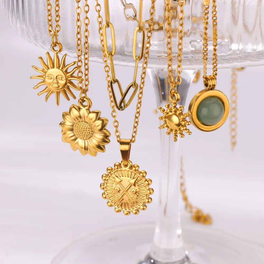 Elegant necklace collection for everyday glamour: sun, sunflower, sunburst and green stone pendants on gold chains.