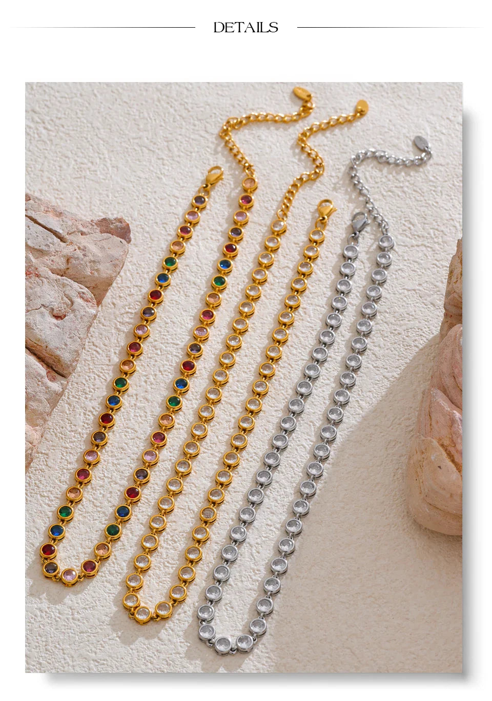 Gold and silver gemstone link bracelets in rainbow colors arranged on a beige textured surface.