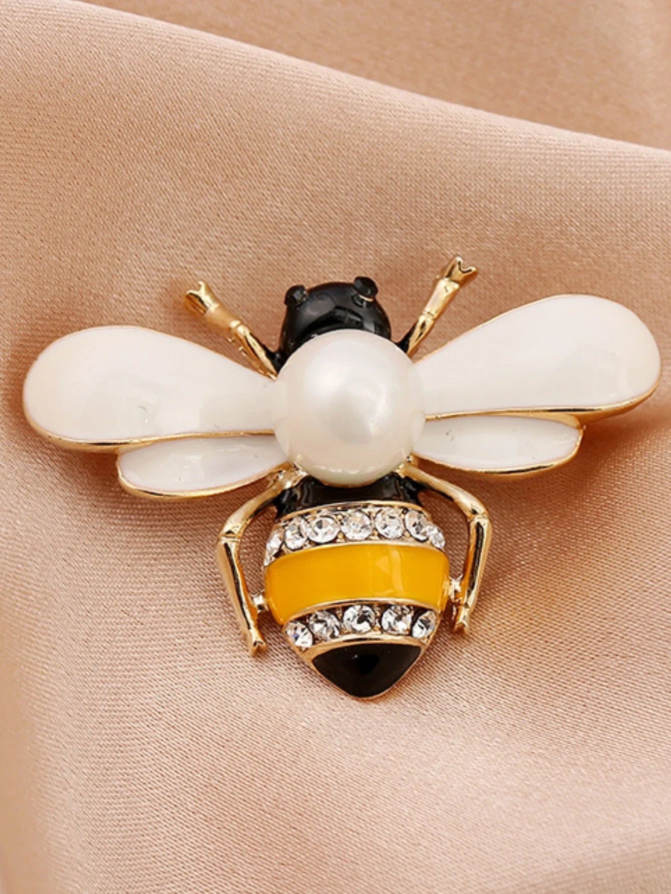 Bee charm keychain with pearl body, white enamel wings, yellow stripes, and rhinestone accents.