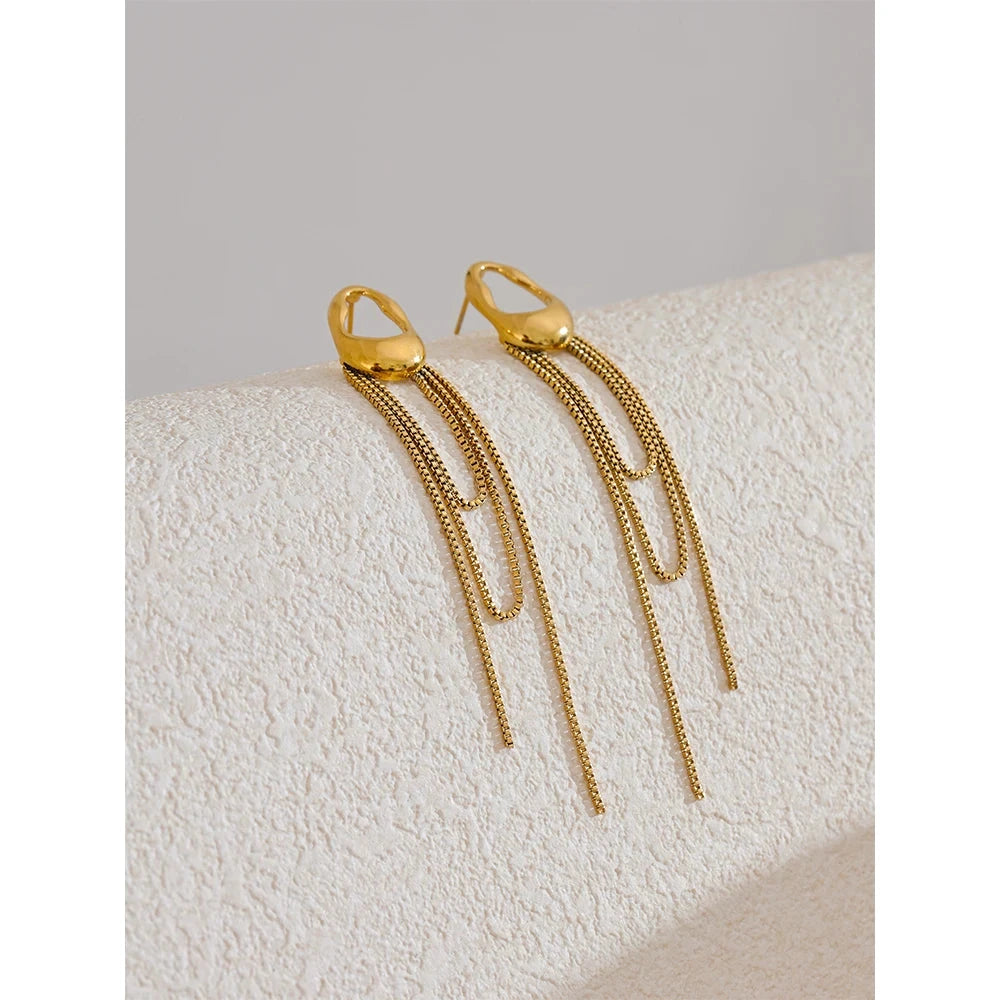 Gold-tone 316L stainless steel geometric tassel chain drop earrings with long fringe chains.
